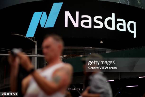 People walk near Nasdaq MarketSite at Times Square on July 12, 2023 in New York City. Nasdaq led the stock market by a gain of more than 1% after a...