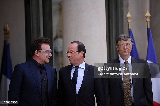 French President Francois Hollande welcomes U2 Frontman Bono, and Microsoft Corp. Chairman Bill Gates at the Elysee Palace on October 10, 2012 in...