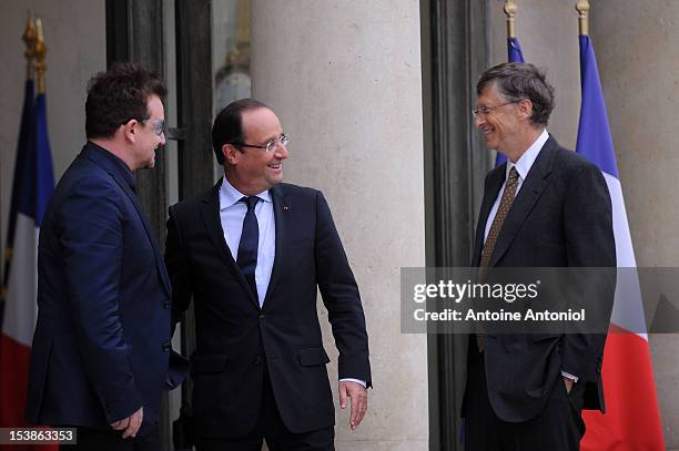 French President Francois Hollande welcomes U2 Frontman Bono, and Microsoft Corp. Chairman Bill Gates at the Elysee Palace on October 10, 2012 in...