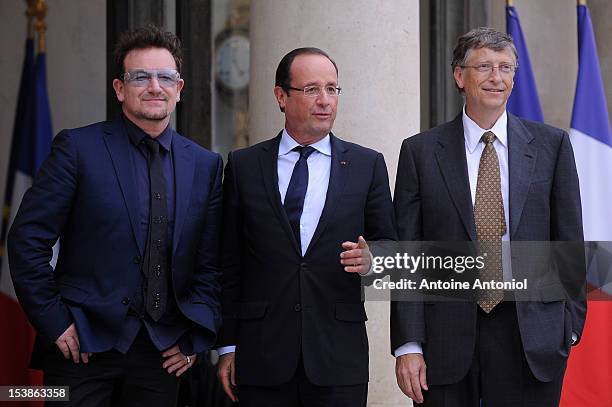 French President Francois Hollande welcomes U2 Frontman Bono, and Microsoft Corp. Chairman Bill Gates at the Elysee Palace on October 10, 2012 in...