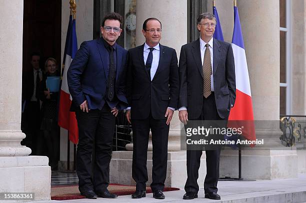French President Francois Hollande welcomes U2 Frontman Bono, and Microsoft Corp. Chairman Bill Gates at the Elysee Palace on October 10, 2012 in...