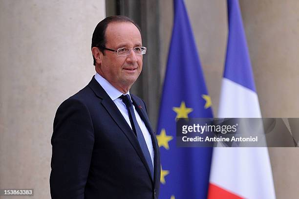 French President Francois Hollande waits for the arrival of U2 Frontman Bono, and Microsoft Corp. Chairman Bill Gates at the Elysee Palace on October...