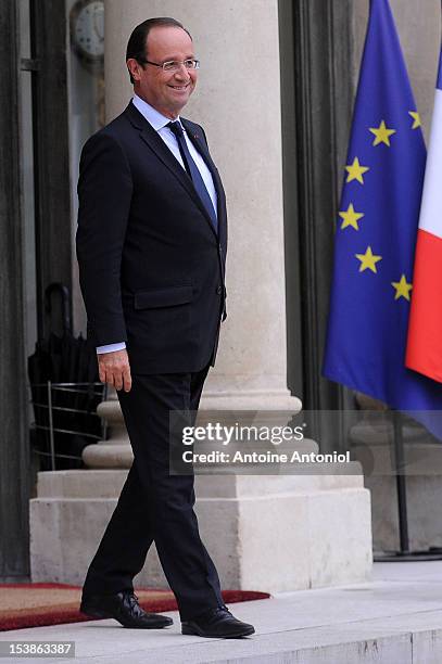 French President Francois Hollande waits for the arrival of U2 Frontman Bono, and Microsoft Corp. Chairman Bill Gates at the Elysee Palace on October...