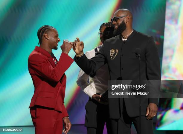 Bronny James and Bryce James present the LeBron James with the Best Record-Breaking Performance award onstage during The 2023 ESPY Awards at Dolby...