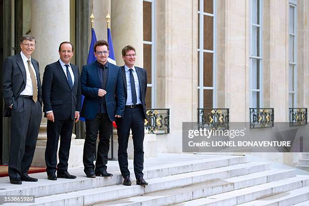 Irish musician and humanitarian activist Bono poses with French President Francois Hollande , Microsoft co-founder turned global philanthropist Bill...