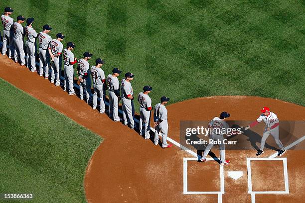 Manager Mike Matheny of the St. Louis Cardinals shakes hands with Davey Johnson of the Washington Nationals prior to Game Three of the National...