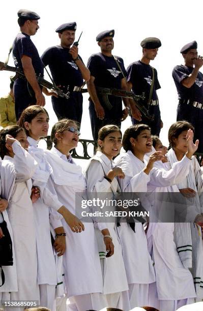 College girls sing national songs as security officials stay alert during a rally orgainsed to show solidarity with Pakistan in Islamabad, 27...