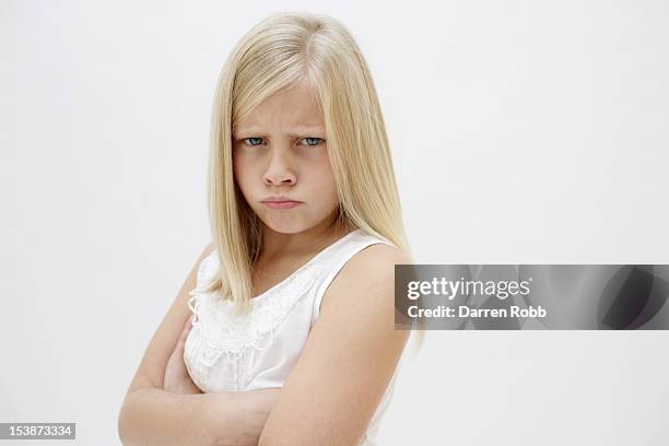 miserable girl with her arms folded, frowning - young girl white background stock pictures, royalty-free photos & images