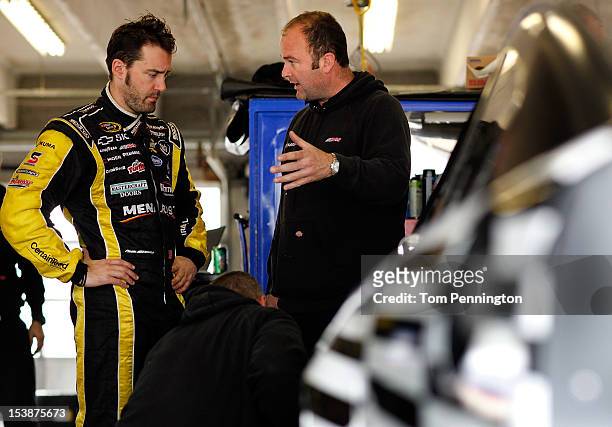 Paul Menard, driver of the CertainTeed Insulation/Menards Chevrolet, talks with his crew during testing at Texas Motor Speedway on October 10, 2012...