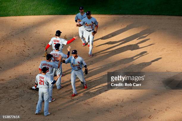The St. Louis Cardinals celebrate after defeating the Washington Nationals to win Game Three of the National League Division Series by a score of 8-0...