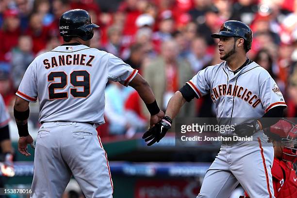 Gregor Blanco of the San Francisco Giants is congratulated by Hector Sanchez after Blanco hits a two-run home run in the second inning against the...