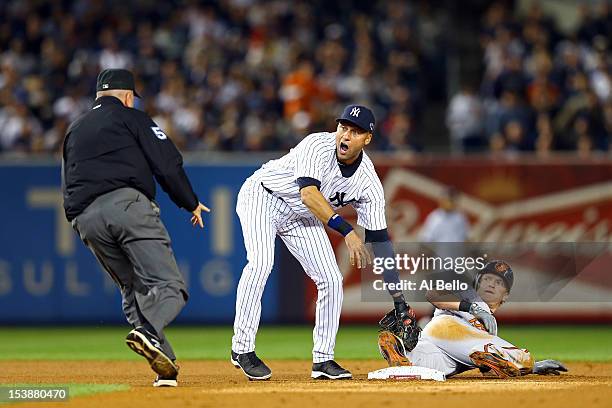 Derek Jeter of the New York Yankees reacts after tagging out Nate McLouth of the Baltimore Orioles in the first inning of Game Three of the American...