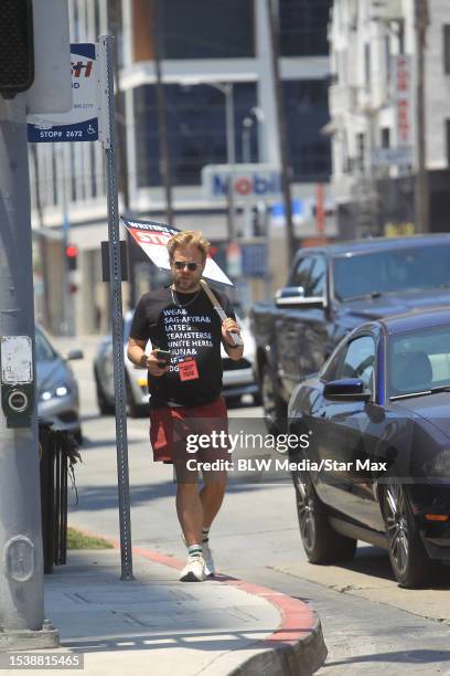 Adam Conover walks the picket line in support of the SAG-AFTRA and WGA strike on July 17, 2023 in Los Angeles, California.