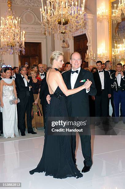 In this handout image provided by Ufficio Stampa Ballo del Giglio, Prince Albert of Monaco and princess Charlene of Monaco attend the 2012 Ballo del...