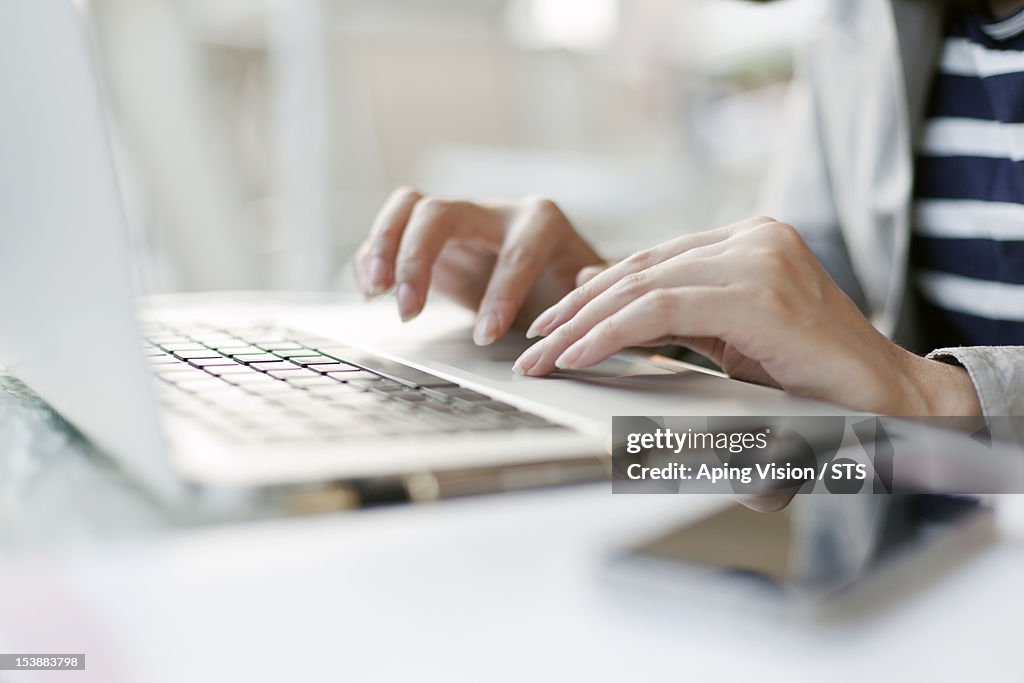 Young woman working with wireless technology