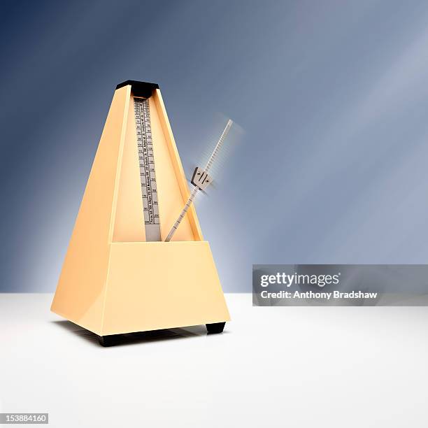 a metronome keeping time - metronome stock pictures, royalty-free photos & images