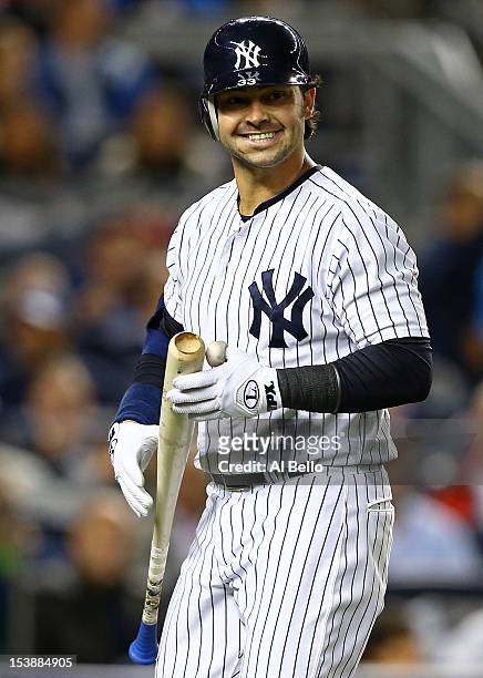 Nick Swisher of the New York Yankees reacts after striking out during Game Three of the American League Division Series against the Baltimore Orioles...