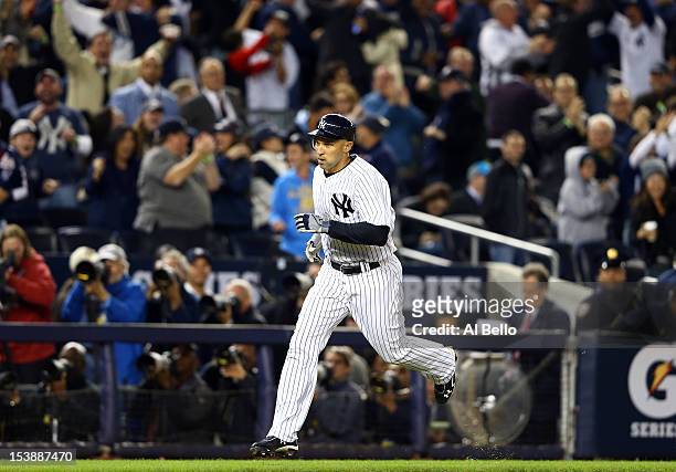 Raul Ibanez of the New York Yankees rounds the bases after hitting a solo home run in the bottom of the ninth inning to tie Game Three of the...