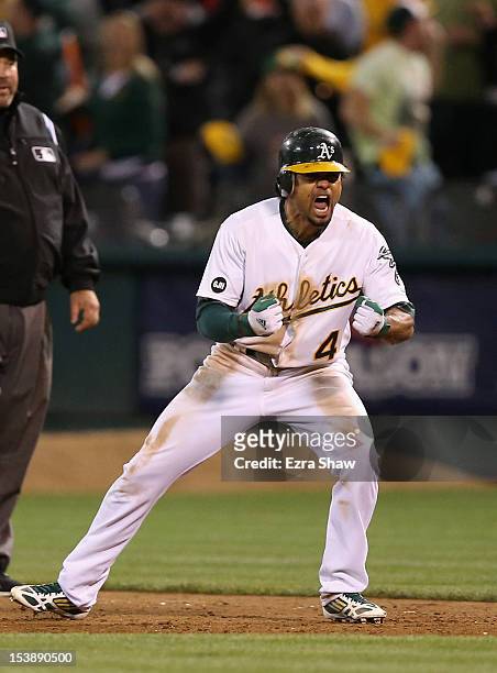 Coco Crisp of the Oakland Athletics celebrates after he hit a game-winning single to beat the Detroit Tigers in the ninth inning of Game Four of the...