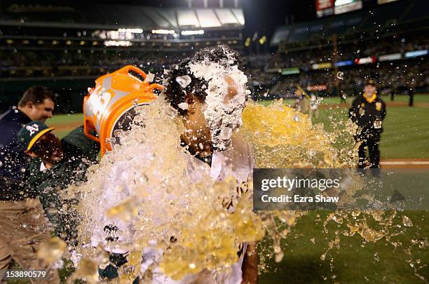 Coco Crisp of the Oakland Athletics is soaked with Gatorade after he had a pie put over his face after he hit a game-winning single to beat the...