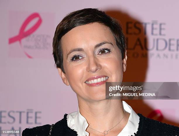 French TV host and journalist Sophie Jovillard poses prior to the illumination of the Opera Garnier in pink in honor of the 20th Anniversary of the...