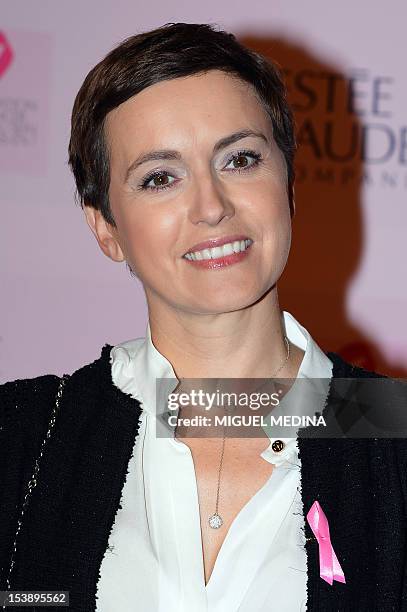 French TV host and journalist Sophie Jovillard poses prior to the illumination of the Opera Garnier in pink in honor of the 20th Anniversary of the...