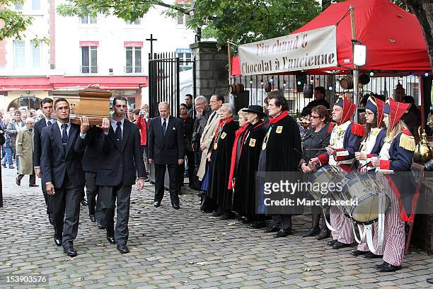 Pall bearers carry the coffin during Director Claude Pinoteau's funeral on October 11, 2012 in Paris, France.