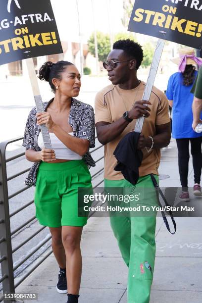 Olly Sholotan and Jazlyn Martin walk the picket line in support of the SAG-AFTRA and WGA strike on July 17, 2023 in Los Angeles, California.