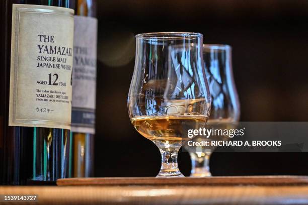 This photo taken on March 27, 2023 shows samples of whisky at the Suntory Yamazaki Distillery where the company's whisky is produced, in the town of...