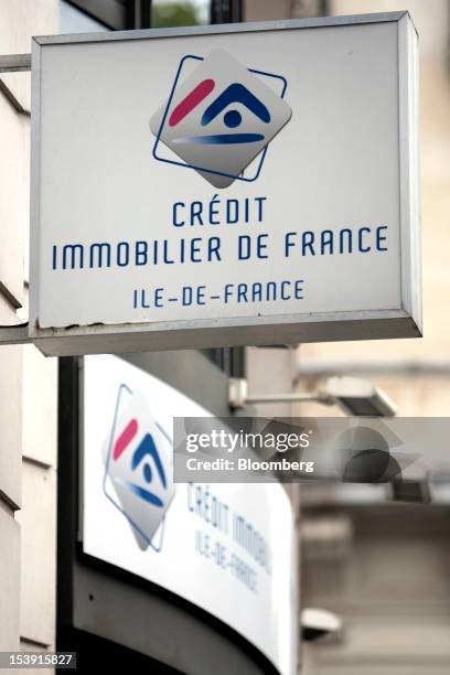 The logo for Credit Immobilier de France , the mortgage bank owned by 56 local cooperative lenders, is seen on display outside a bank branch in...