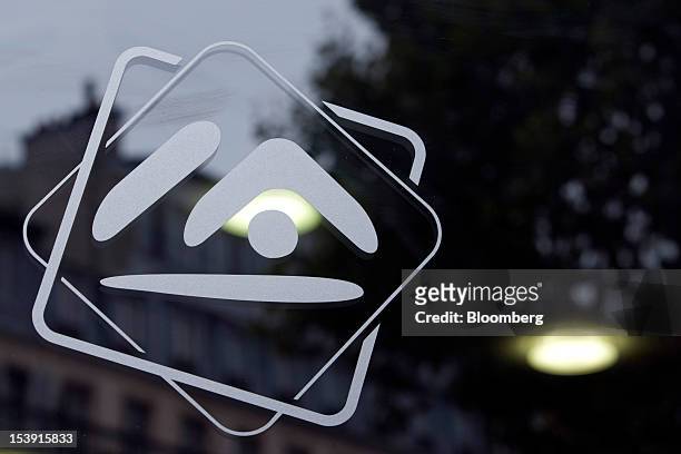 The logo for Credit Immobilier de France , the mortgage bank owned by 56 local cooperative lenders, is seen displayed on a window at a bank branch in...