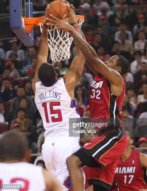 Ryan Hollins of the Los Angeles Clippers dunks against Mickell Gladness of the Miami Heat during a pre-season game as a part of the 2012 NBA China...