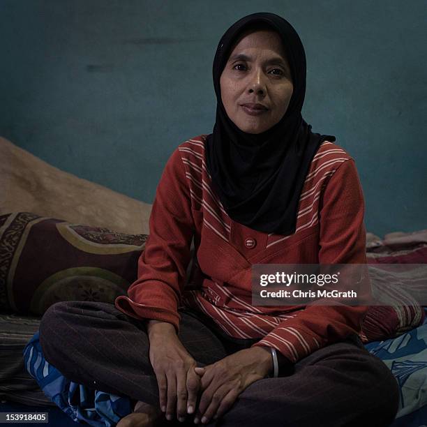 Bali bombing widow Endang Isnani, 41 poses for a portrait in her home in Bali on October 11, 2012 in Kuta, Indonesia. Endang lost her husband Aris...