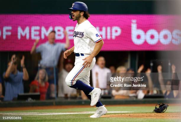 Josh Smith of the Texas Rangers reacts after scoring the winning run on a wild pitch against the Tampa Bay Rays in the ninth inning at Globe Life...