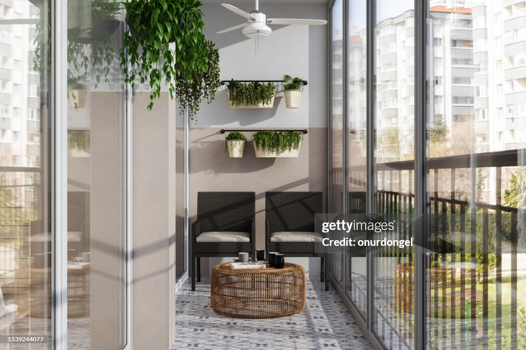 Modern Enclosed Balcony With Wicker Chairs, Coffee Table And Creeper Plants
