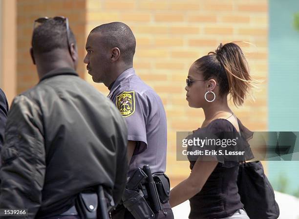 Woman is escorted into the public funeral for singer Lisa "Left Eye" Lopes at the New Birth Missionary Baptist Church May 2, 2002 in Lithonia, GA....