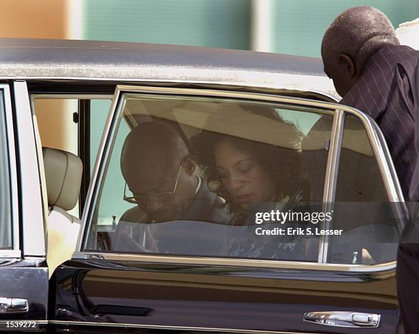 Man and woman arrive for the funeral of singer Lisa "Left Eye" Lopes at the New Birth Missionary Baptist Church May 2, 2002 in Lithonia, GA. Lopes...