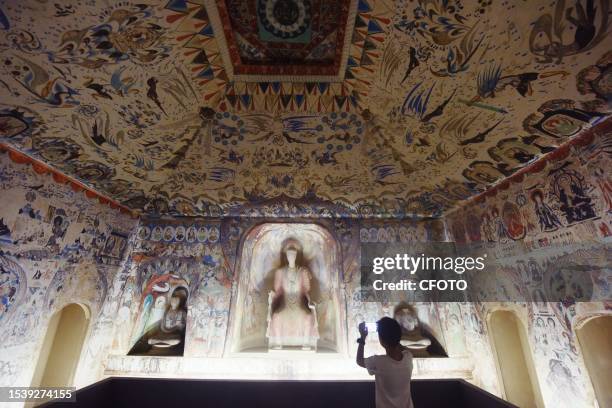 Photo taken on July 18, 2023 shows the equal-scale restoration of Cave 285 of Dunhuang using digital technology at the China Silk Museum in Hangzhou,...