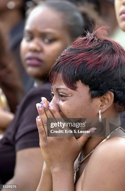 Brittany Hampton cries while waiting in line to attend the public funeral of singer Lisa "Left Eye" Lopes at the New Birth Missionary Baptist Church...