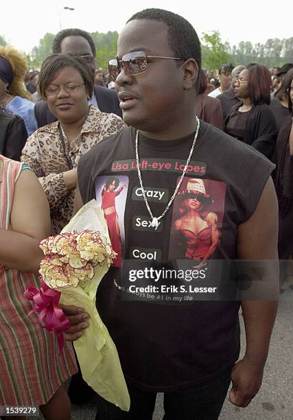 Donnell Gilbert wears a homemade T-shirt while waiting in line to attend the public funeral of singer Lisa "Left Eye" Lopes at the New Birth...