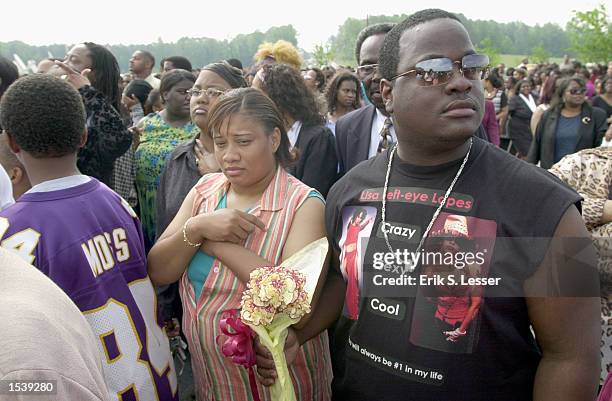 Donnell Gilbert wears a homemade T-shirt while waiting in line to attend the public funeral of singer Lisa "Left Eye" Lopes at the New Birth...