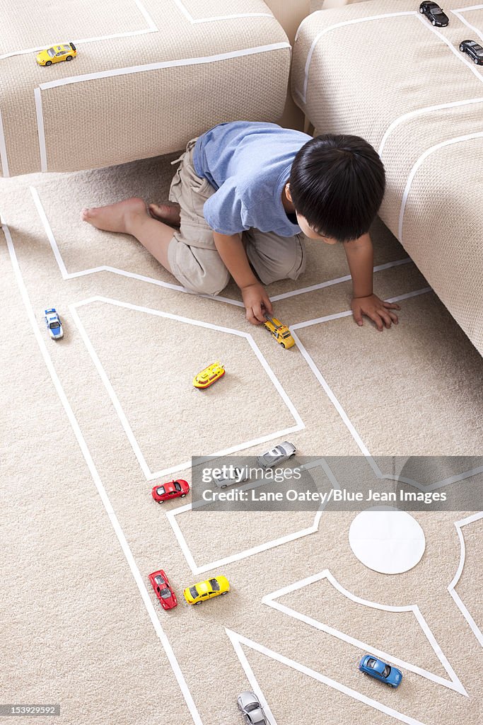 Boy playing toy car at home