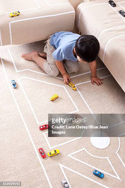 boy playing toy car at home - single lane road - fotografias e filmes do acervo