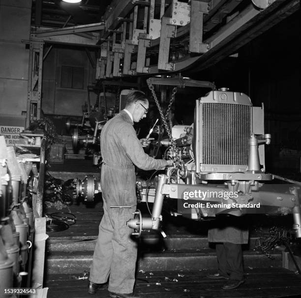 Mechanic working on the assembly line at the Standard Motor Company's car plant in Canley, Coventry, December 15th 1958.