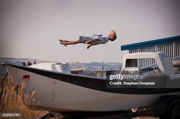 boy bouncing on an unseen trampoline - 重力場 ストックフォトと画像