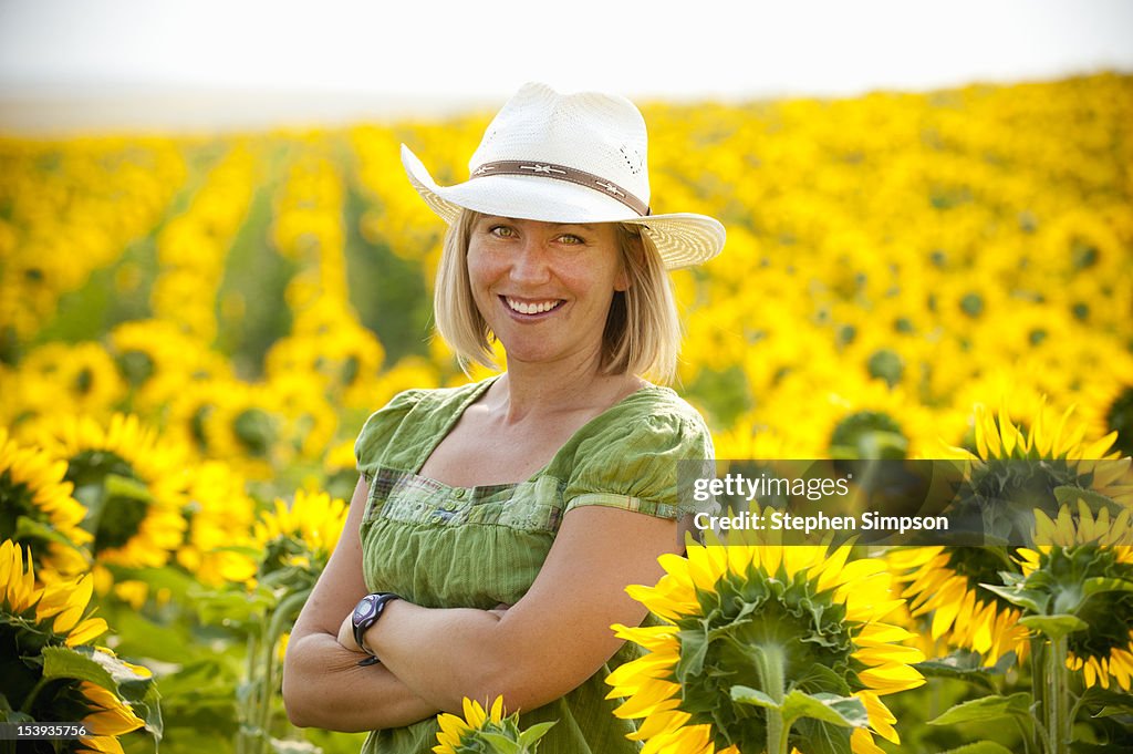 Farming woman in field of sunflowers