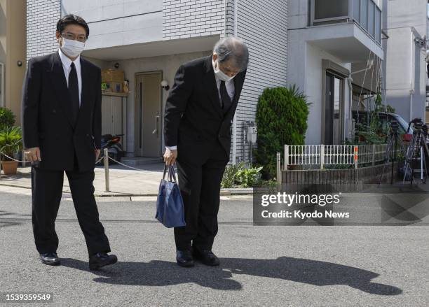 Kyoto Animation Co. President Hideaki Hatta bows on July 18 before attending a memorial ceremony at the site of an arson attack four years earlier on...