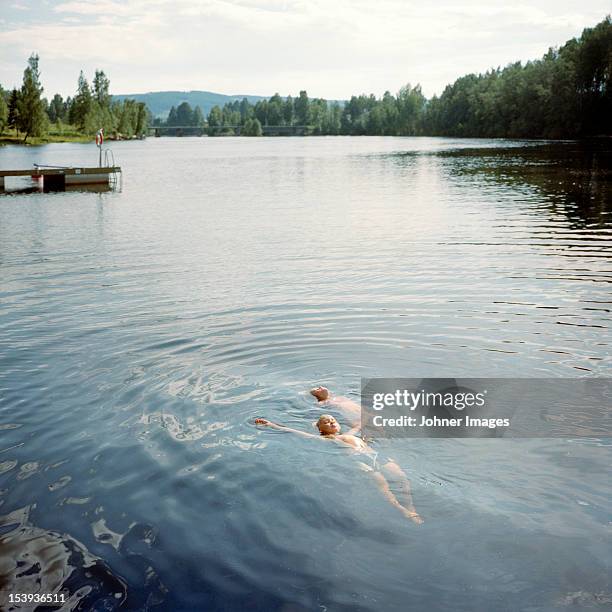 kids swimming in lake - dalarna stock pictures, royalty-free photos & images