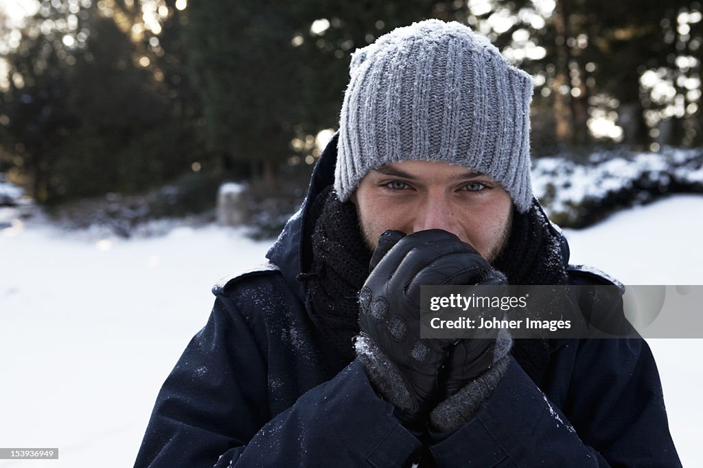 Portrait of man smiling in snow