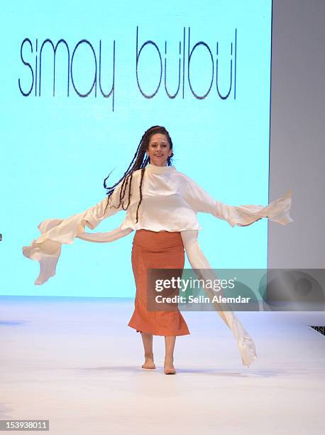 Designer Simay Bulbul walks the runway during the Simay Bulbul show as part of Istanbul Fashion Week S/S 2013 on October 11, 2012 in Istanbul, Turkey.